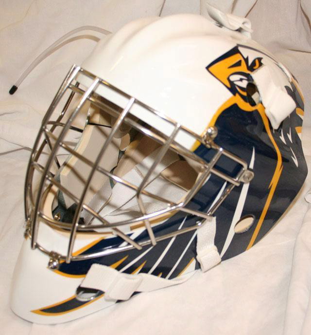 A white hockey goalie mask with a yellow and black panther logo.