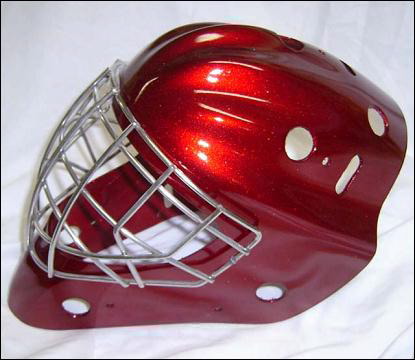 A shiny red hockey goalie mask with metal cage on a white background.