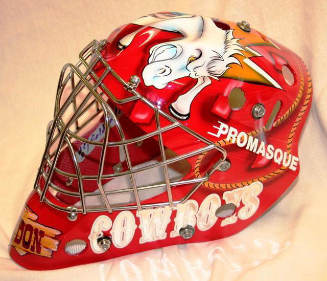 Custom painted hockey goalie mask with cowboy and lightning motifs.