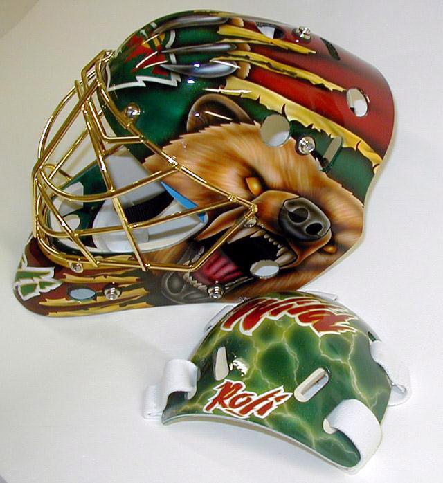Two intricately painted goalie masks with detailed animal artwork.
