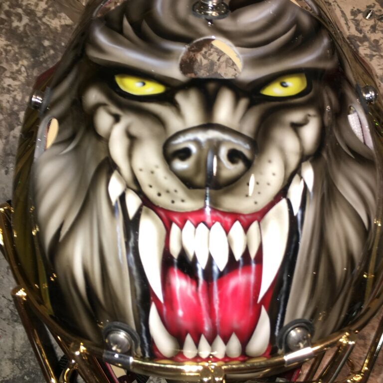 Fierce werewolf face with glowing yellow eyes and sharp teeth.